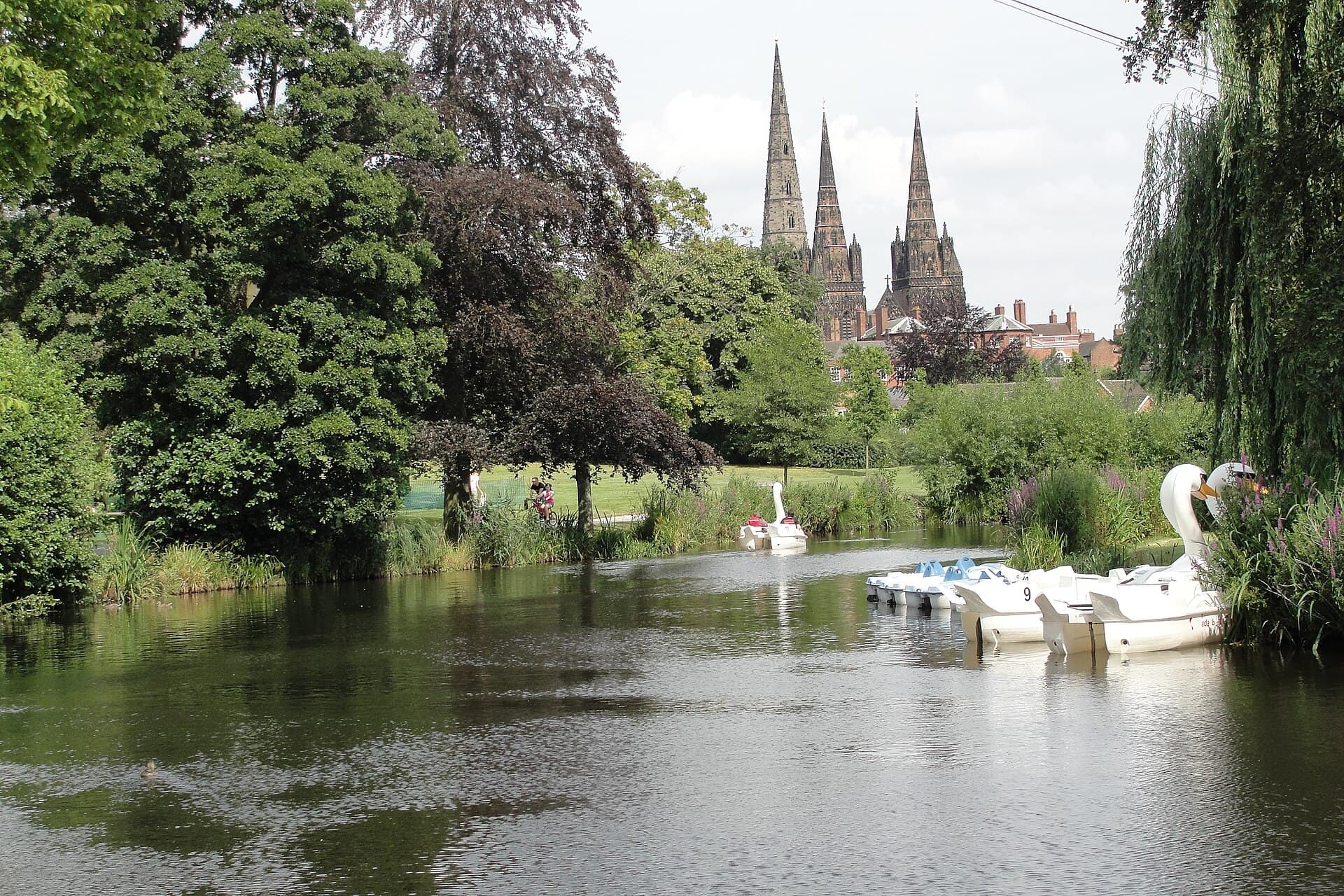 Lichfield Cathedral three spires seen across Beacon Park lake, Staffordshire